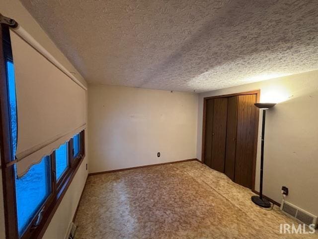 unfurnished bedroom featuring a textured ceiling