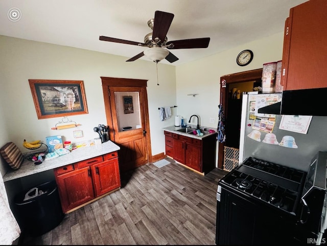 kitchen with light hardwood / wood-style floors, black range with gas cooktop, fridge, and sink