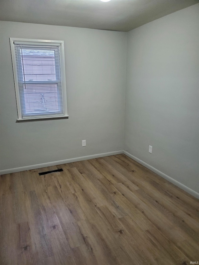 unfurnished room with light wood-type flooring