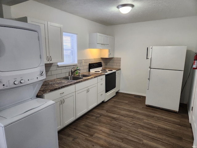 kitchen featuring decorative backsplash, white appliances, sink, stacked washer and clothes dryer, and white cabinetry