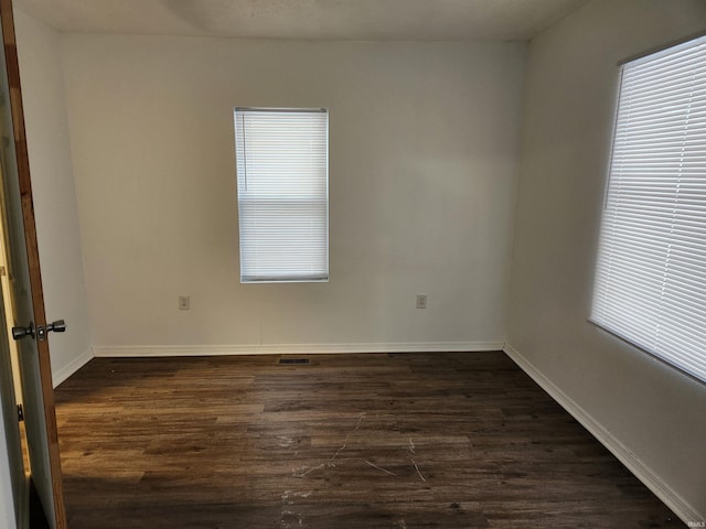 empty room featuring dark wood-type flooring