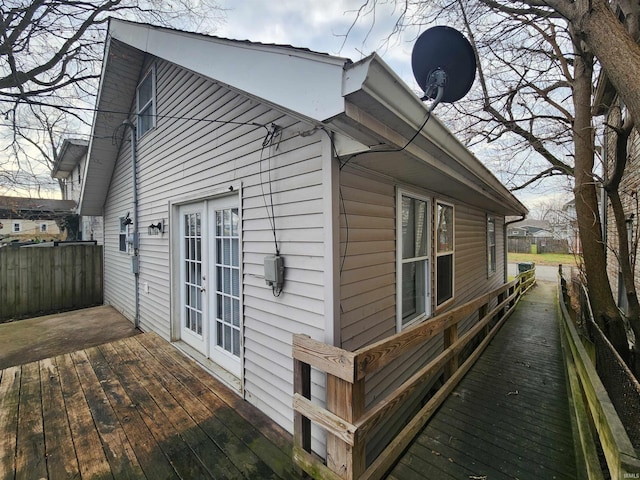 view of side of home featuring a deck and french doors