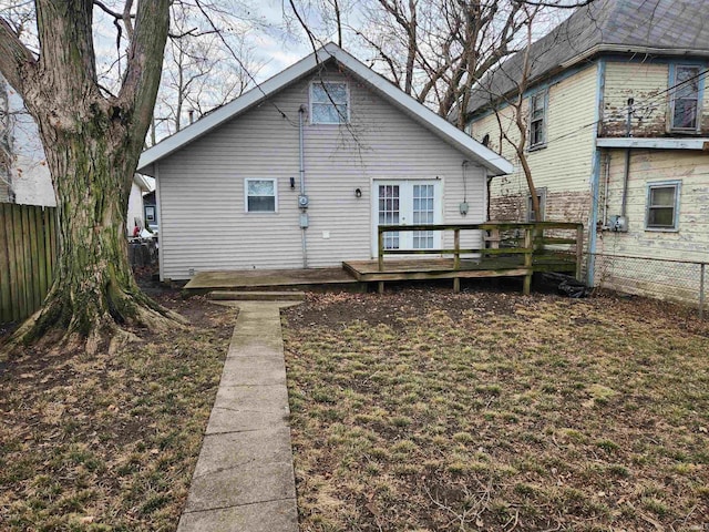 rear view of property with a wooden deck