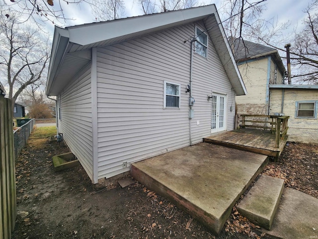 back of house with a wooden deck and french doors