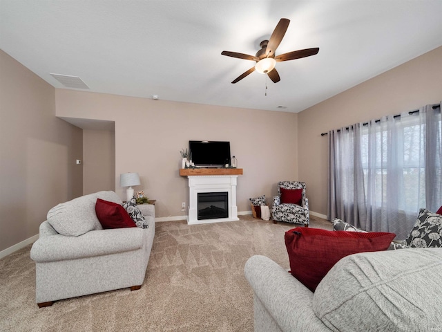 carpeted living room featuring ceiling fan