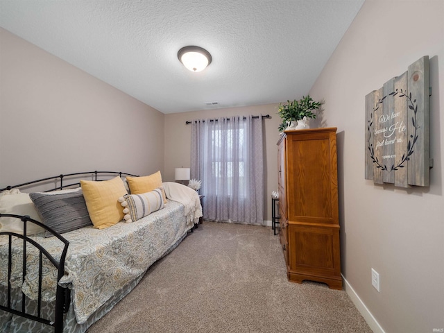 carpeted bedroom with a textured ceiling