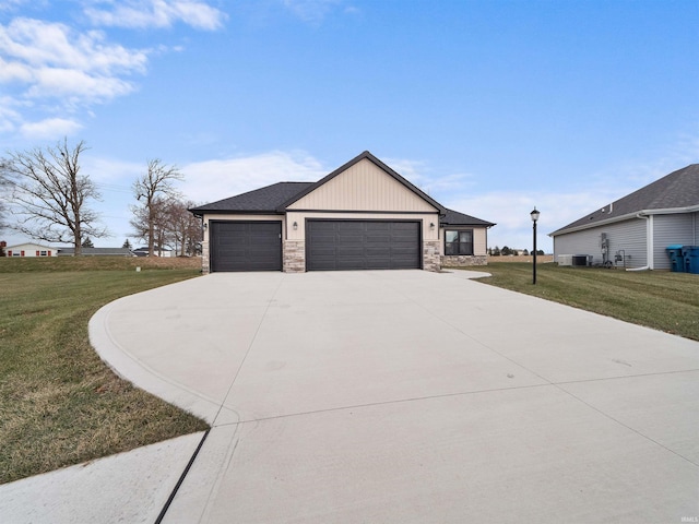 view of front of home featuring a front yard, a garage, and cooling unit