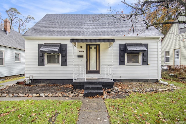 bungalow-style home with a front lawn