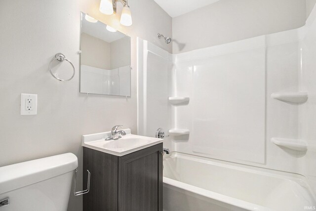 full bathroom with bathtub / shower combination, vanity, and toilet