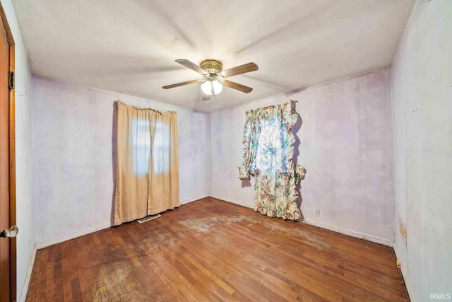 empty room featuring hardwood / wood-style floors and ceiling fan