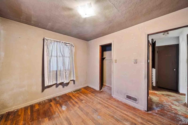 spare room with wood-type flooring