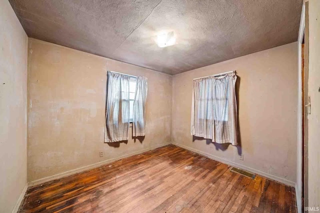 empty room with hardwood / wood-style floors