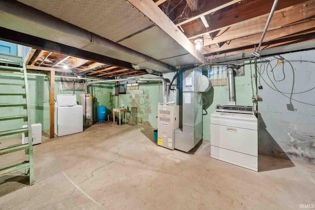 basement featuring washer and dryer, heating unit, and water heater