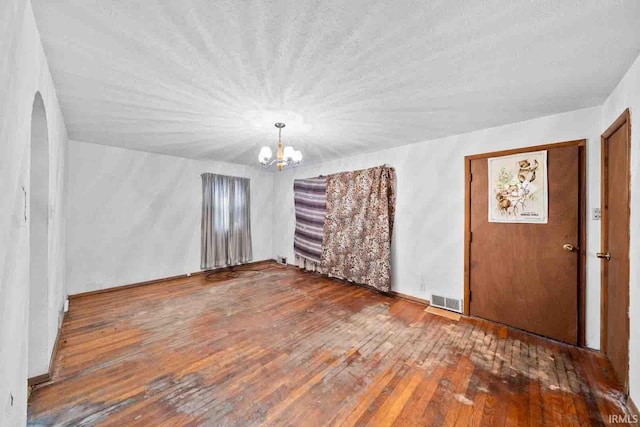 foyer entrance featuring hardwood / wood-style floors and a chandelier