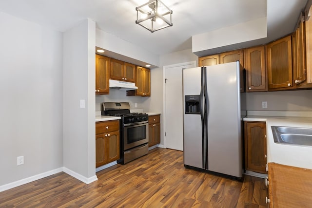 kitchen featuring dark hardwood / wood-style flooring, stainless steel appliances, and sink