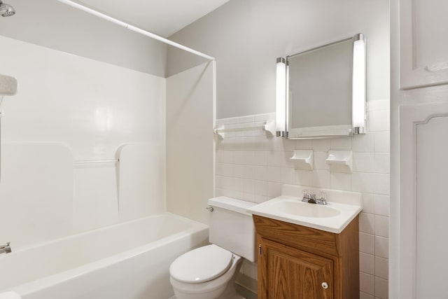 full bathroom featuring tasteful backsplash, shower / bath combination, vanity, tile walls, and toilet