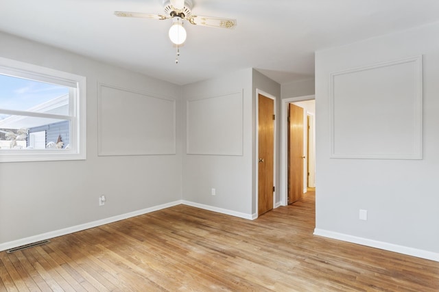 empty room with light hardwood / wood-style floors and ceiling fan