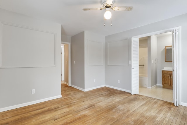 empty room with ceiling fan and light wood-type flooring