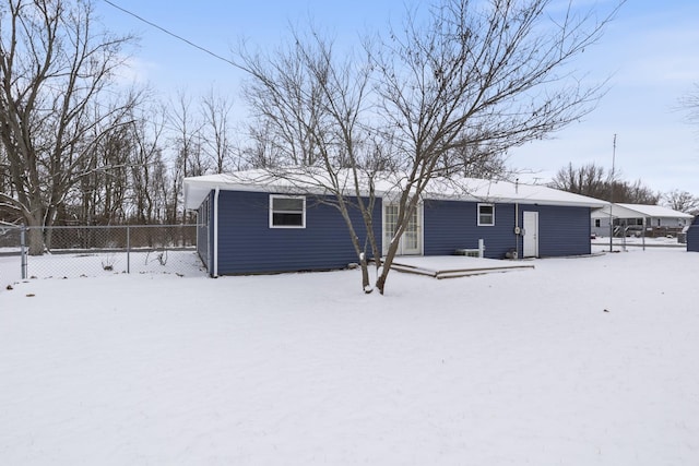 view of snow covered rear of property