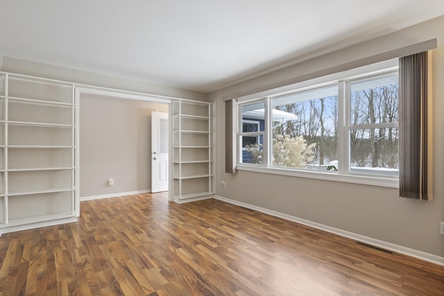 unfurnished bedroom featuring dark hardwood / wood-style floors