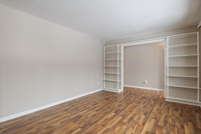 unfurnished bedroom featuring dark hardwood / wood-style flooring