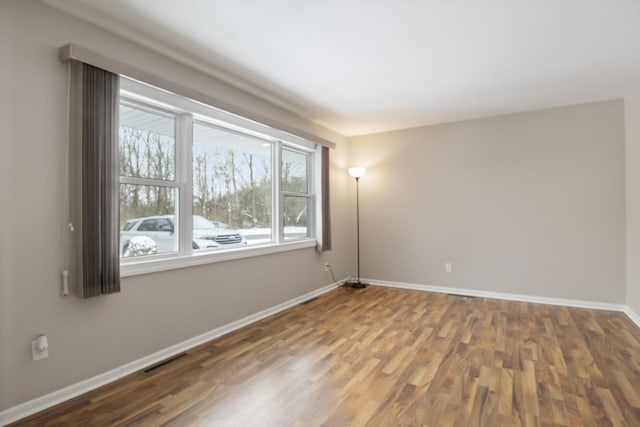 unfurnished room with hardwood / wood-style floors