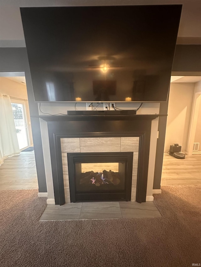 room details featuring carpet flooring and a tile fireplace