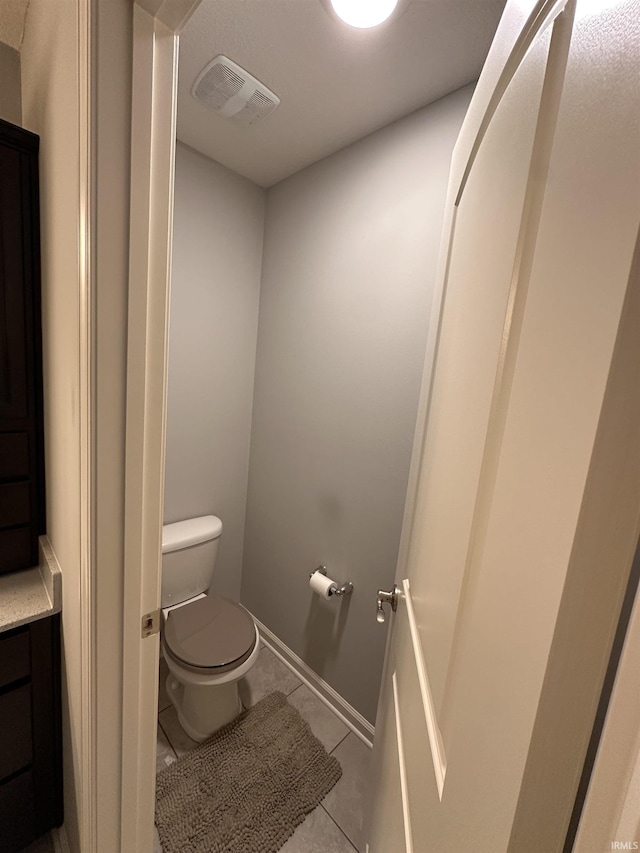 bathroom with tile patterned flooring and toilet