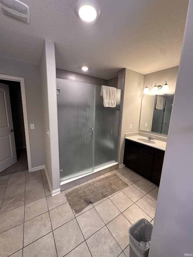 bathroom featuring tile patterned floors, vanity, and a textured ceiling