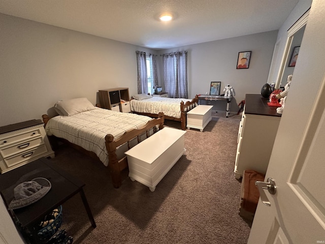 carpeted bedroom with a textured ceiling