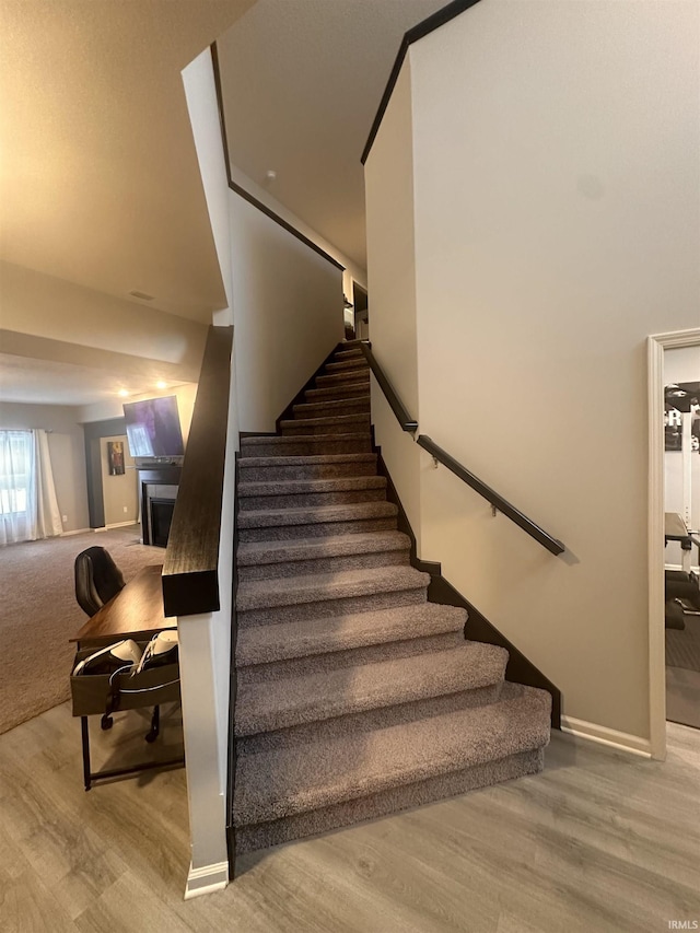 stairs featuring hardwood / wood-style flooring