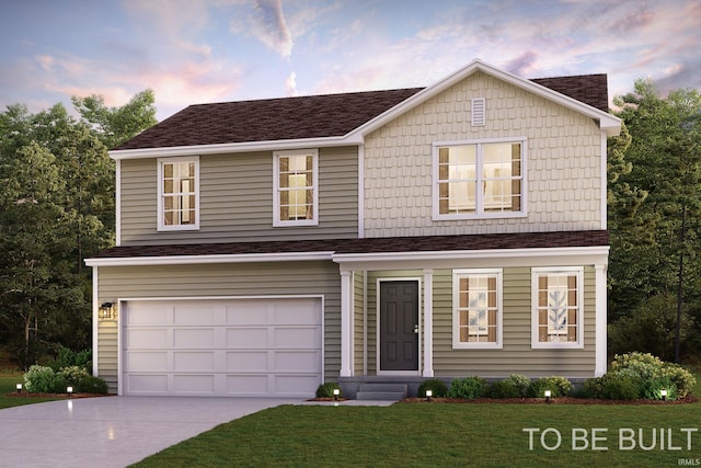 view of front of home featuring a yard and a garage