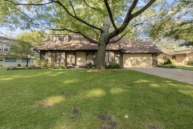 view of front facade with a front yard and a garage