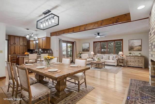 dining room with ceiling fan, beam ceiling, and light hardwood / wood-style flooring