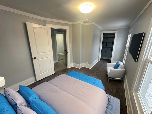 bedroom with crown molding and dark carpet