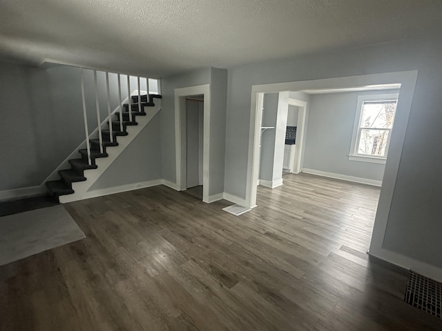 basement with wood-type flooring and a textured ceiling