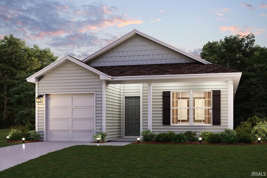 view of front facade with a lawn and a garage