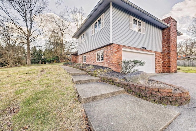 view of side of home with a garage and a yard