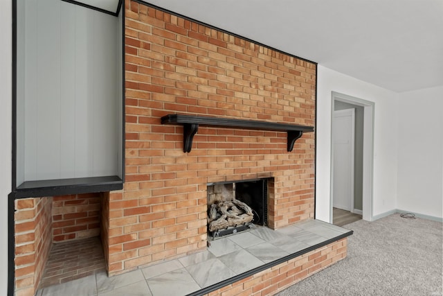 interior details with carpet and a brick fireplace