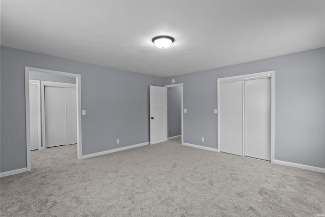 unfurnished bedroom featuring light carpet