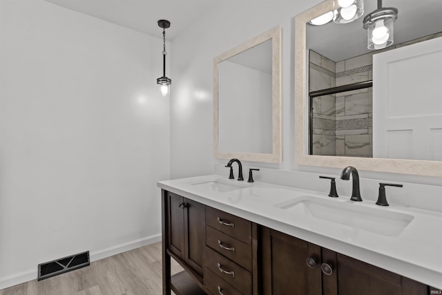 bathroom featuring vanity, a shower with shower door, and hardwood / wood-style flooring