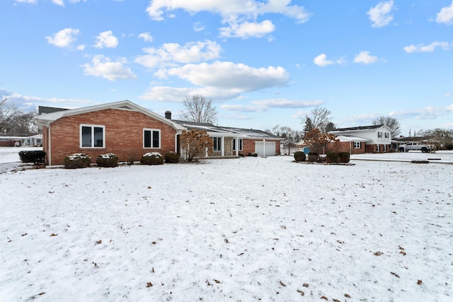 snow covered property featuring a garage