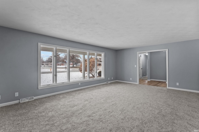 unfurnished room featuring light carpet