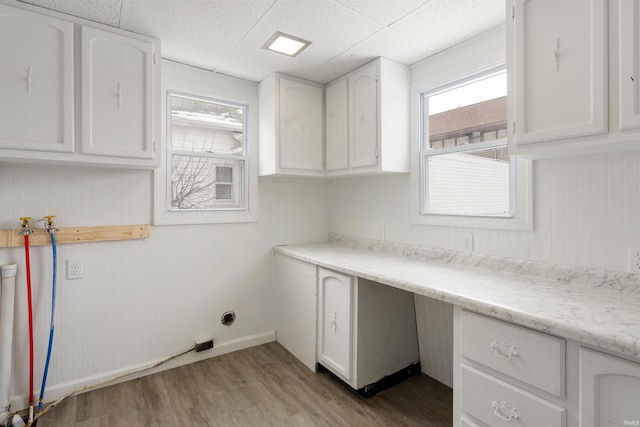 washroom featuring light hardwood / wood-style floors, cabinets, and hookup for a washing machine