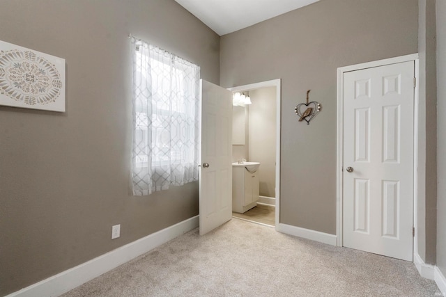 carpeted bedroom with ensuite bath