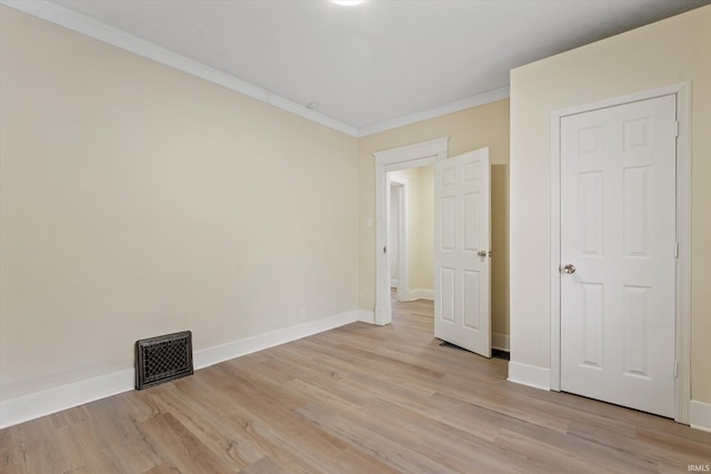 unfurnished bedroom with light hardwood / wood-style floors and ornamental molding