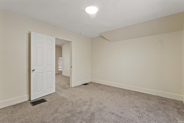 spare room with light colored carpet