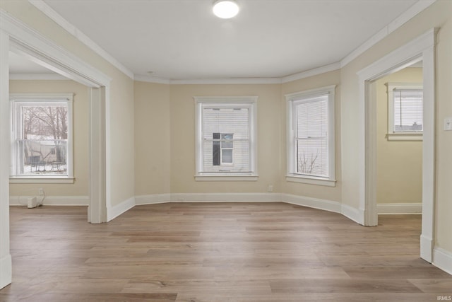 spare room featuring crown molding and light hardwood / wood-style floors