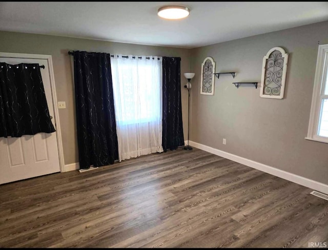 spare room featuring dark wood-type flooring