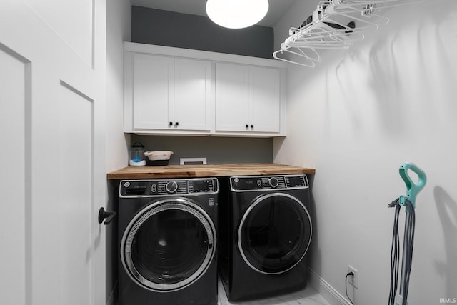 washroom featuring cabinets and separate washer and dryer